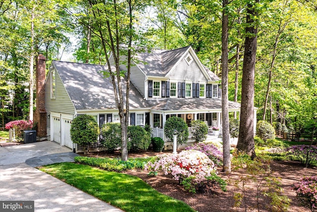 1399 Old Quincy Ln, Reston, VA 20194 - view of front of home with concrete driveway, a shingled roof, covered porch, and a chimney