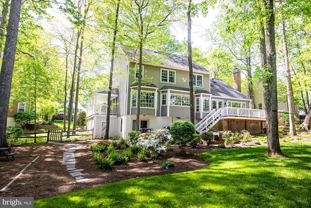 1399 Old Quincy Ln, Reston, VA 20194 - rear view of property with stairway, a wooden deck, a chimney, a sunroom, and a shingled roof
