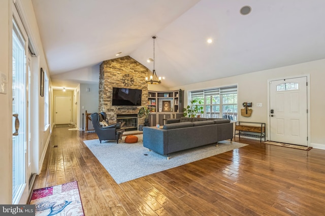 4 Steeplebush Trl, Southampton, NJ 08088 - living area featuring hardwood / wood-style floors, a chandelier, a stone fireplace, high vaulted ceiling, and baseboards