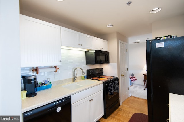 304 Academy St Unit 202, Cambridge, MD 21613 - kitchen featuring black appliances, white cabinetry, light wood-style flooring, light countertops, and recessed lighting