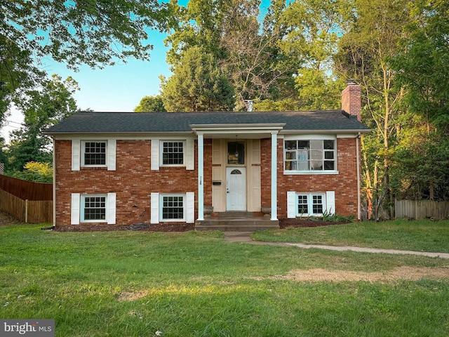 2208 Princess Anne Ln, Woodbridge, VA 22191 - split foyer home featuring a chimney, brick siding, and roof with shingles