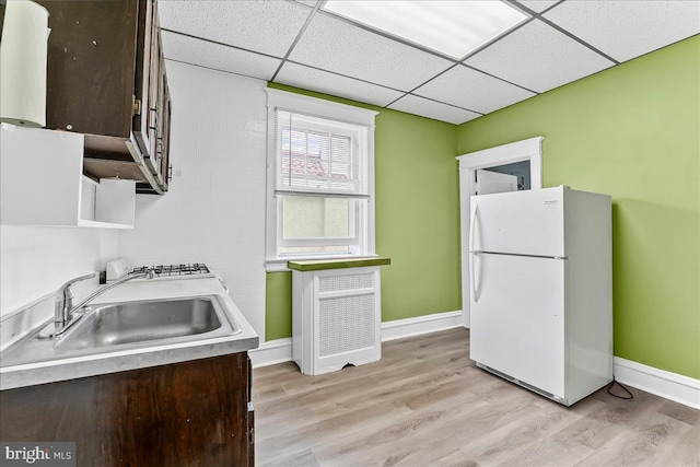 736 Poplar St, Sharon Hill, PA 19079 - kitchen with freestanding refrigerator, a sink, dark brown cabinets, a drop ceiling, and light countertops