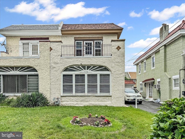 736 Poplar St, Sharon Hill, PA 19079 - back of property featuring a balcony, stucco siding, a lawn, and roof with shingles