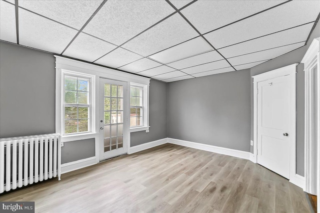 736 Poplar St, Sharon Hill, PA 19079 - unfurnished room featuring radiator heating unit, wood finished floors, a paneled ceiling, and baseboards