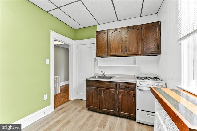 736 Poplar St, Sharon Hill, PA 19079 - kitchen featuring gas range gas stove, a sink, a paneled ceiling, light wood-style flooring, and light countertops