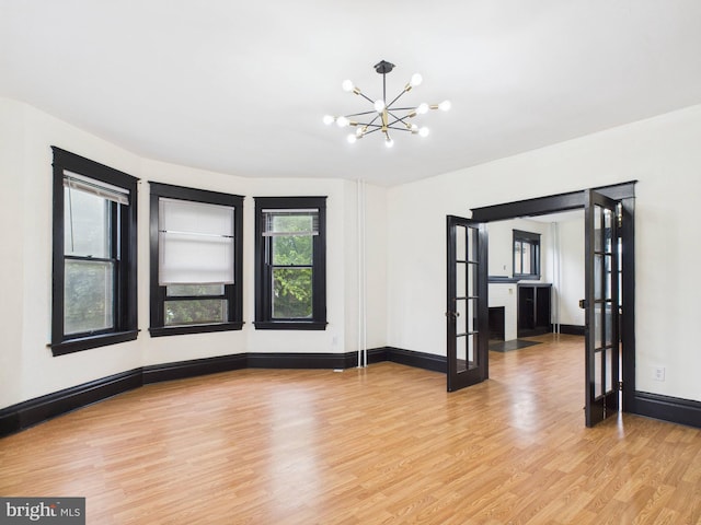3437 Market St, Camp Hill, PA 17011 - spare room featuring a chandelier, light wood-style flooring, and french doors
