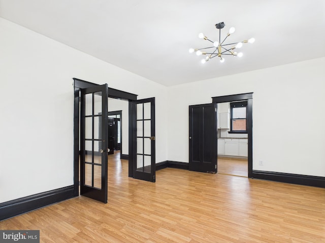 3437 Market St, Camp Hill, PA 17011 - spare room with french doors, a chandelier, and light wood-style flooring