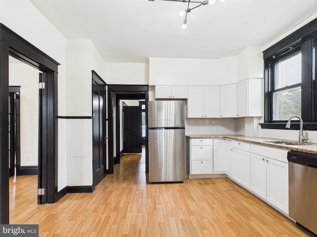 3437 Market St, Camp Hill, PA 17011 - kitchen with appliances with stainless steel finishes, white cabinetry, light wood-style floors, and light stone counters