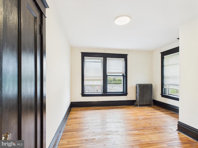 3437 Market St, Camp Hill, PA 17011 - unfurnished room with radiator heating unit, plenty of natural light, and light wood-style flooring