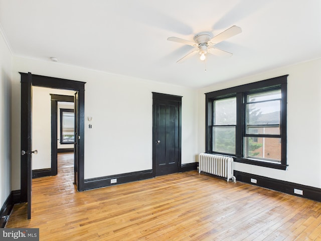 3437 Market St, Camp Hill, PA 17011 - unfurnished room with radiator, light wood-type flooring, ceiling fan, a smoke detector, and crown molding