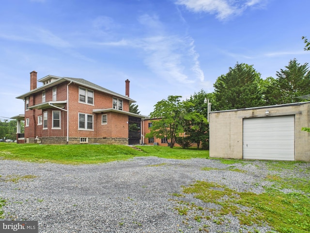 3437 Market St, Camp Hill, PA 17011 - view of side of property featuring brick siding, a chimney, a garage, gravel driveway, and a lawn