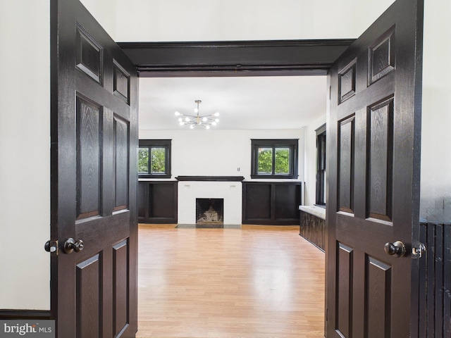 3437 Market St, Camp Hill, PA 17011 - entryway featuring light wood finished floors, a chandelier, and a fireplace with flush hearth