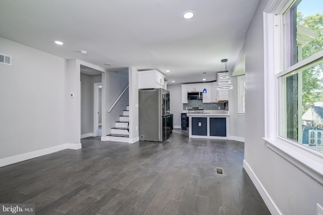 8808 Edmonston Rd, College Park, MD 20740 - unfurnished living room featuring recessed lighting, stairs, and dark wood-type flooring