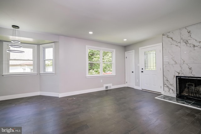 8808 Edmonston Rd, College Park, MD 20740 - unfurnished living room with dark wood-style flooring, recessed lighting, and a fireplace
