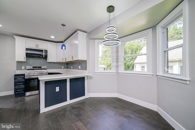 8808 Edmonston Rd, College Park, MD 20740 - kitchen with light countertops, appliances with stainless steel finishes, white cabinets, backsplash, and hanging light fixtures