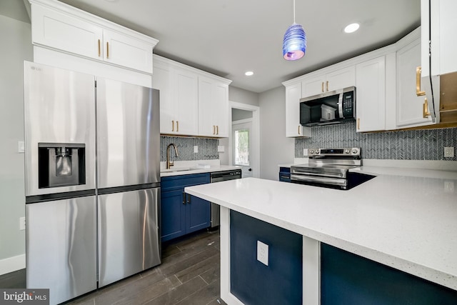 8808 Edmonston Rd, College Park, MD 20740 - kitchen with stainless steel appliances, blue cabinetry, decorative backsplash, white cabinetry, and recessed lighting