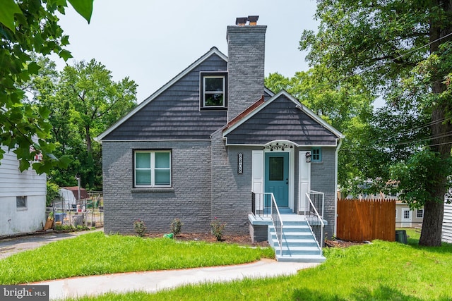 8808 Edmonston Rd, College Park, MD 20740 - view of front facade with a chimney and brick siding