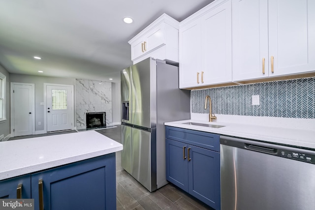 8808 Edmonston Rd, College Park, MD 20740 - kitchen with stainless steel appliances, blue cabinets, white cabinets, tasteful backsplash, and recessed lighting