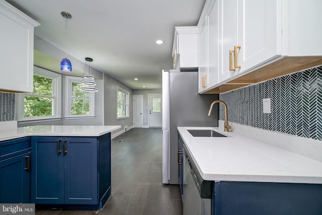 8808 Edmonston Rd, College Park, MD 20740 - kitchen with blue cabinetry, stainless steel dishwasher, tasteful backsplash, white cabinetry, and hanging light fixtures