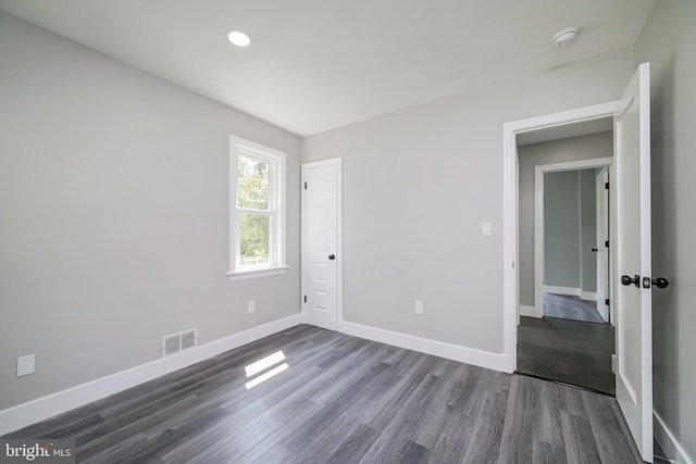 8808 Edmonston Rd, College Park, MD 20740 - unfurnished room with dark wood-type flooring, recessed lighting, and a smoke detector