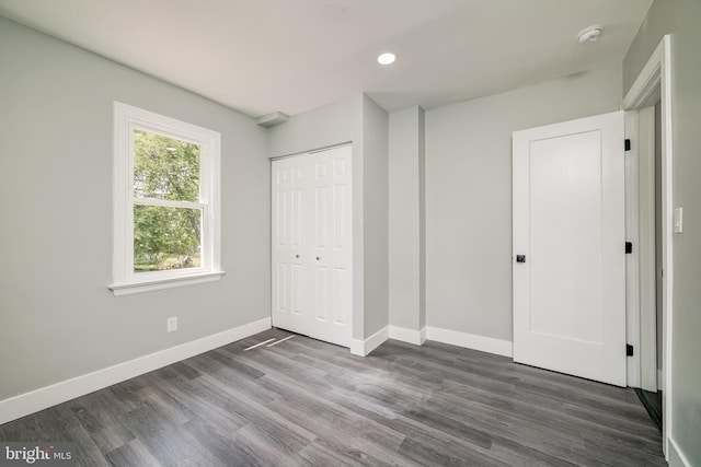 8808 Edmonston Rd, College Park, MD 20740 - unfurnished bedroom featuring dark wood-style floors, a closet, and recessed lighting