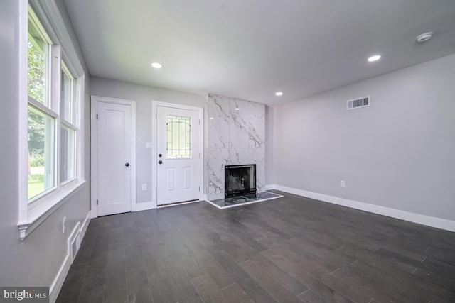 8808 Edmonston Rd, College Park, MD 20740 - unfurnished living room with dark wood-style floors, healthy amount of natural light, a premium fireplace, and recessed lighting