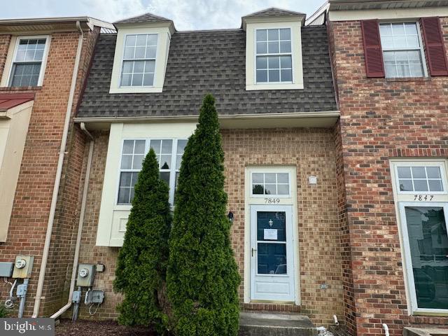 7849 Hidden Crk Unit 24, Baltimore, MD 21226 - view of front of property featuring a shingled roof and brick siding