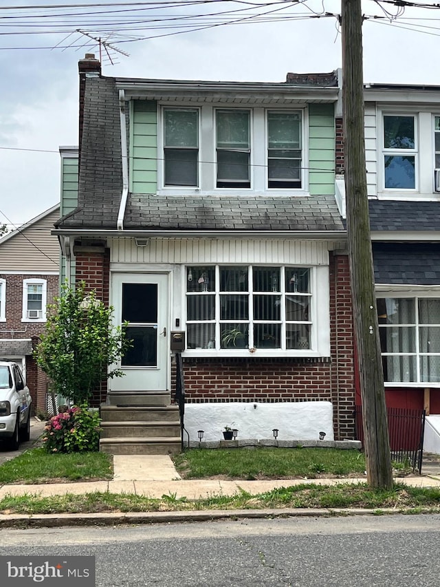 1102 Shelmire Ave, Philadelphia, PA 19111 - view of property featuring entry steps, a chimney, and brick siding
