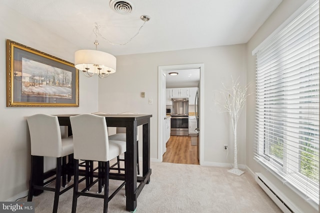 74 Ashton Way Unit 74, West Chester, PA 19380 - dining area featuring baseboard heating, light carpet, and a chandelier