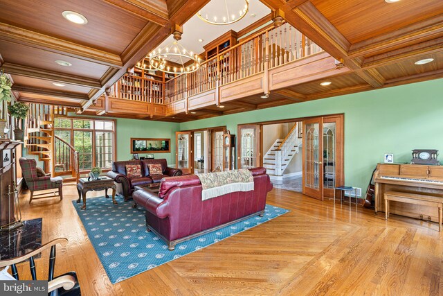 1214 Hunt Seat Dr, Lower Gwynedd, PA 19002 - living area with coffered ceiling, stairs, a chandelier, crown molding, and a wood ceiling with exposed beams