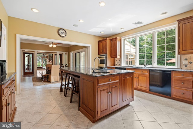 1214 Hunt Seat Dr, Lower Gwynedd, PA 19002 - kitchen with black dishwasher, a breakfast bar area, brown cabinetry, oven, and recessed lighting