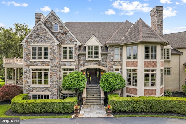 1214 Hunt Seat Dr, Lower Gwynedd, PA 19002 - view of front facade with a chimney, stucco siding, roof with shingles, and stone siding
