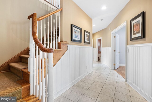 1214 Hunt Seat Dr, Lower Gwynedd, PA 19002 - stairway featuring wainscoting, tile patterned flooring, and a decorative wall