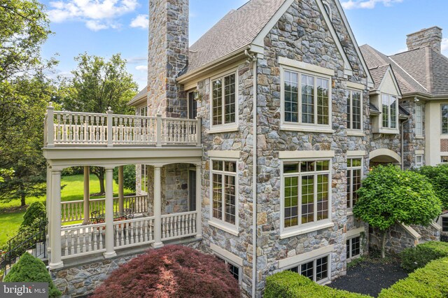 1214 Hunt Seat Dr, Lower Gwynedd, PA 19002 - rear view of property with a chimney, a balcony, stone siding, and a shingled roof