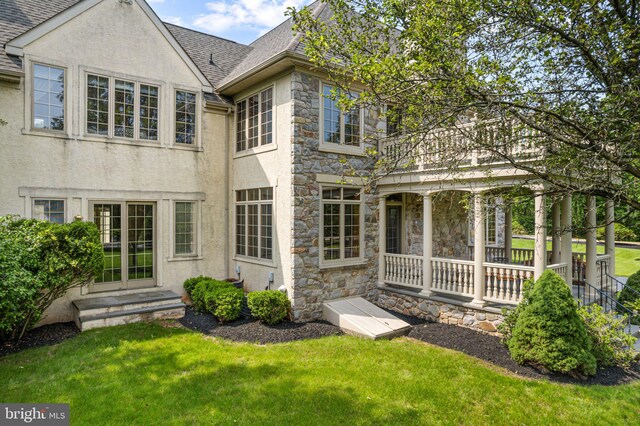 1214 Hunt Seat Dr, Lower Gwynedd, PA 19002 - rear view of property with stone siding, a lawn, roof with shingles, and stucco siding