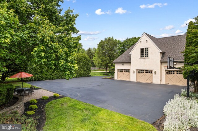 1214 Hunt Seat Dr, Lower Gwynedd, PA 19002 - view of property exterior featuring roof with shingles, stucco siding, and asphalt driveway