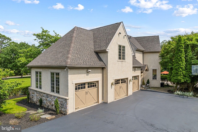 1214 Hunt Seat Dr, Lower Gwynedd, PA 19002 - view of front of house with stucco siding, roof with shingles, driveway, and stone siding