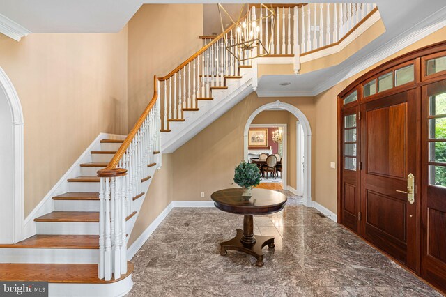 1214 Hunt Seat Dr, Lower Gwynedd, PA 19002 - entrance foyer featuring arched walkways, a towering ceiling, stairs, crown molding, and marble finish flooring