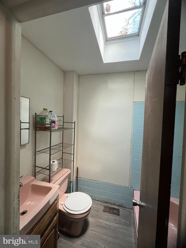 1206 Lakeshore Dr, Camden, NJ 08104 - bathroom with vanity, wood finished floors, and a skylight