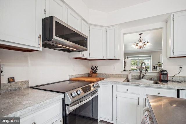13536 Ruddy Duck Rd, Clifton, VA 20124 - kitchen with appliances with stainless steel finishes, a chandelier, white cabinetry, and light countertops