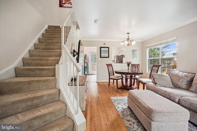 13536 Ruddy Duck Rd, Clifton, VA 20124 - living area with stairway, light wood finished floors, ornamental molding, and a chandelier