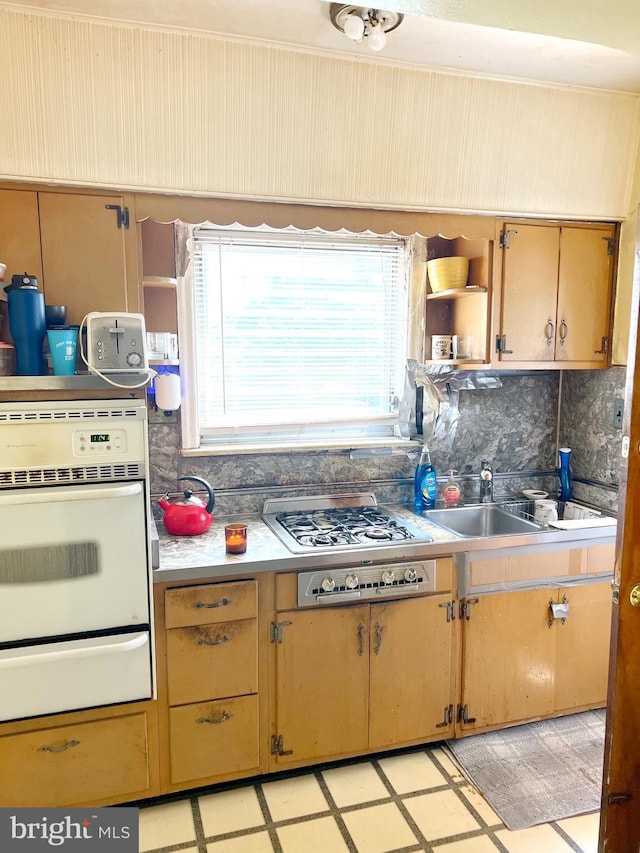 635 N 67th St, Philadelphia, PA 19151 - kitchen with white oven, light floors, a warming drawer, backsplash, and light countertops