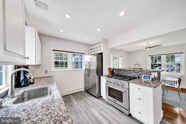 10 Shaw Dr, Kingston, NJ 08528 - kitchen with appliances with stainless steel finishes, a baseboard heating unit, white cabinets, light wood-type flooring, and a peninsula
