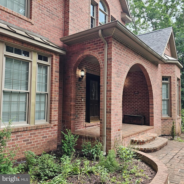 681 Hillcrest Dr, New Creek, WV 26743 - view of exterior entry featuring a shingled roof and brick siding