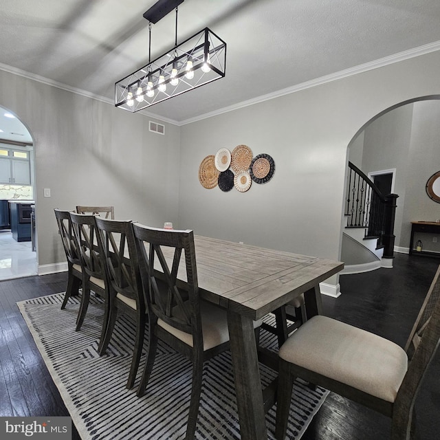 681 Hillcrest Dr, New Creek, WV 26743 - dining space with arched walkways, dark wood-style floors, stairway, and crown molding