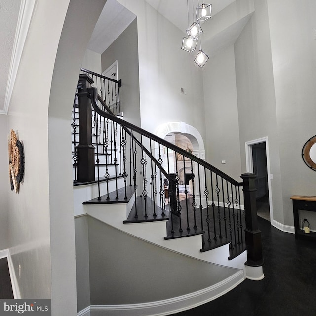 681 Hillcrest Dr, New Creek, WV 26743 - stairway featuring a towering ceiling and arched walkways