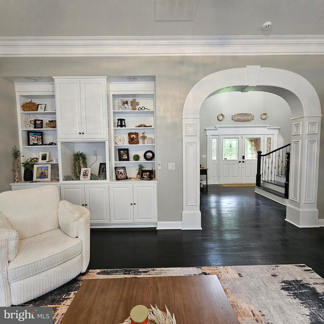681 Hillcrest Dr, New Creek, WV 26743 - living room featuring arched walkways, crown molding, stairs, dark wood-type flooring, and built in shelves