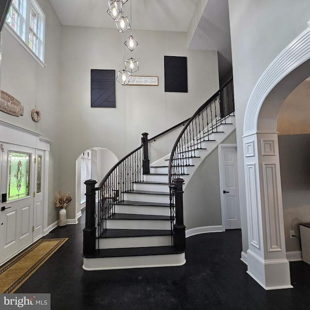 681 Hillcrest Dr, New Creek, WV 26743 - foyer entrance with arched walkways, a towering ceiling, and stairs