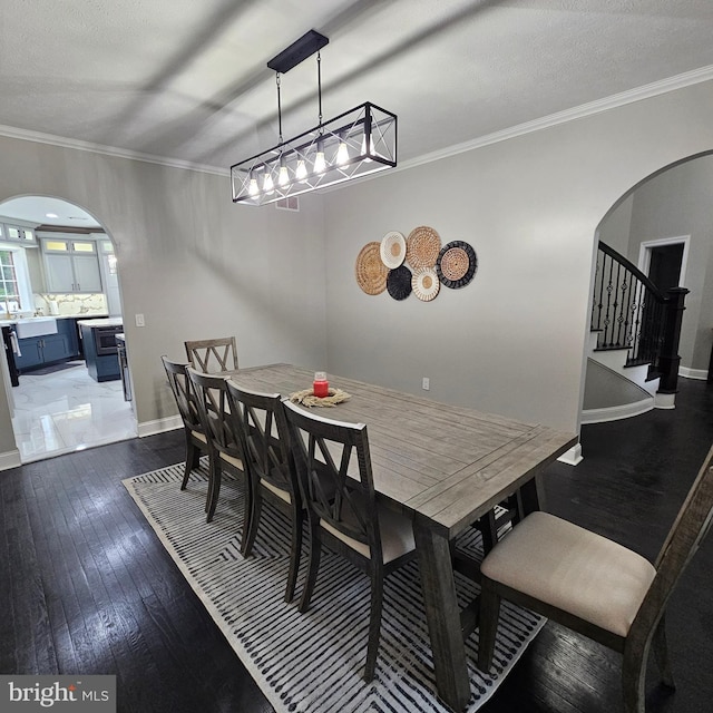 681 Hillcrest Dr, New Creek, WV 26743 - dining room with arched walkways, wood-type flooring, stairs, crown molding, and a textured ceiling