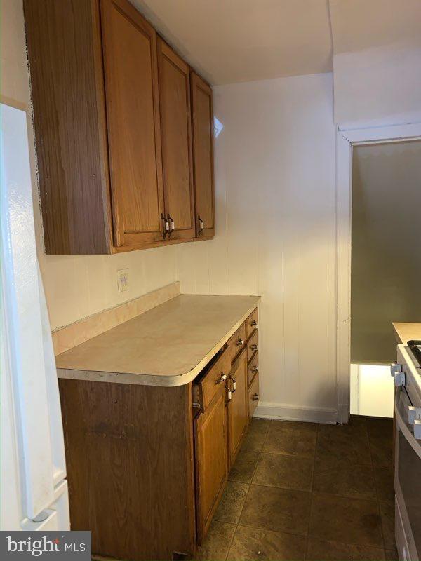 1642 Rosedale St NE, Washington, DC 20002 - kitchen with brown cabinetry, light countertops, and stainless steel stove